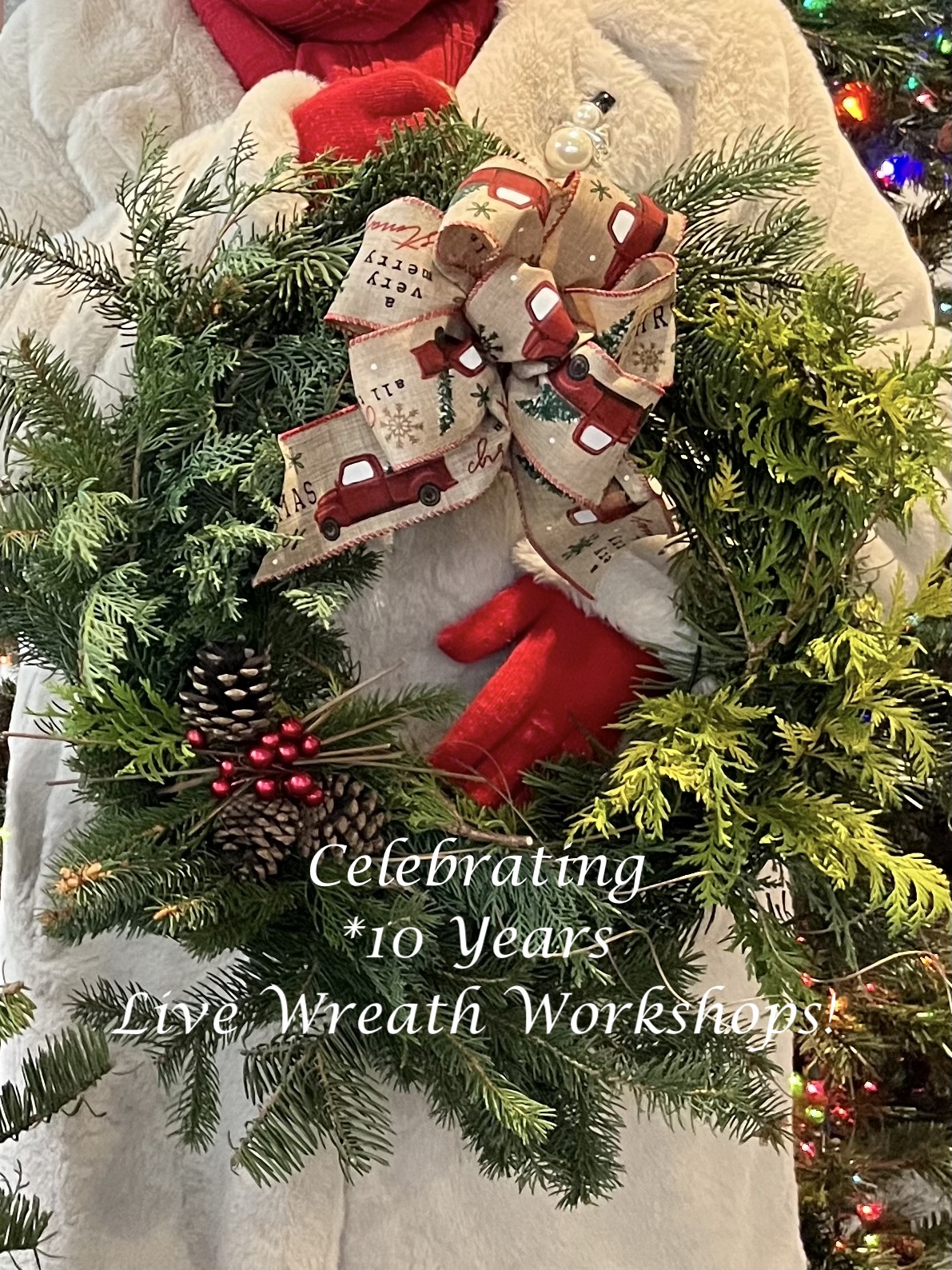 a gloved person holding a wreath they made at the workshop